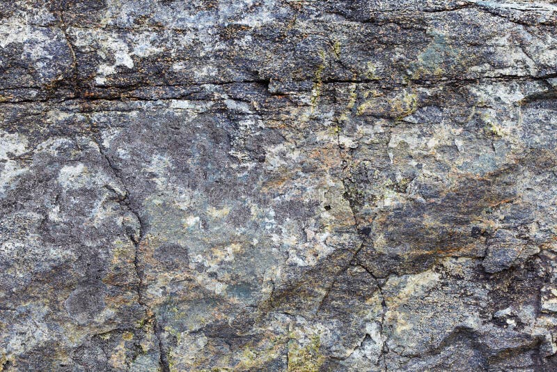 Granite rock with stains and cracks - a natural background royalty free stock photo