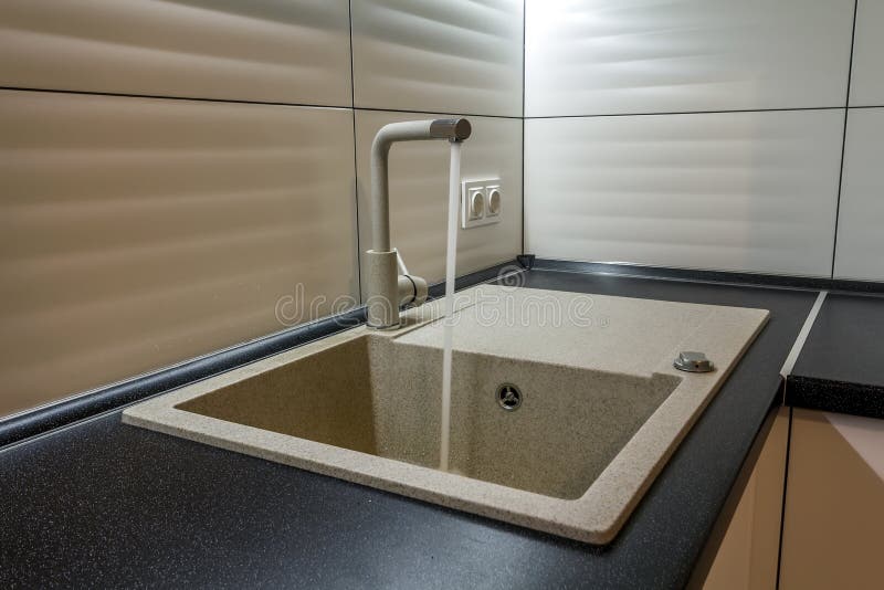 Granite Sink and Water Faucet in New Modern Kitchen Interior Stock