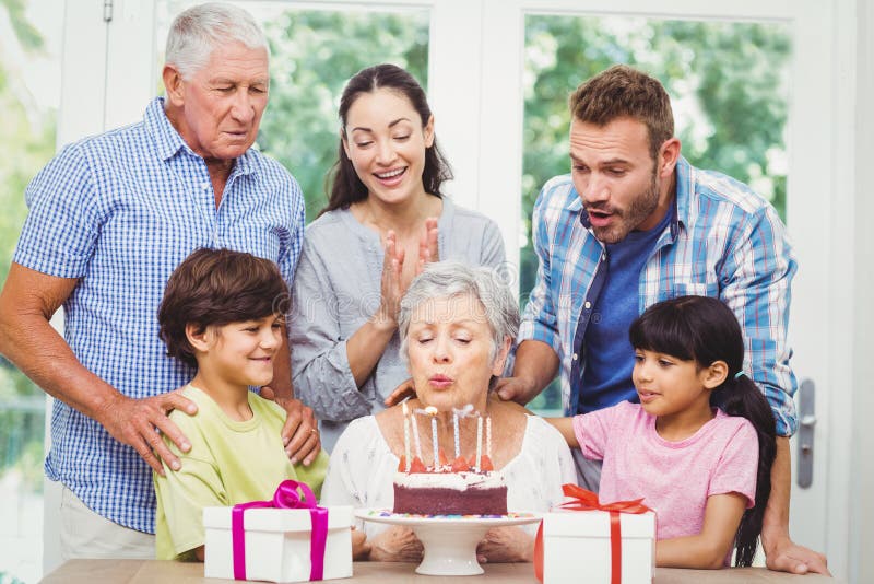 Granny blowing birthday candles with family stock photos Granny blowing birthday candles with family stock photos
