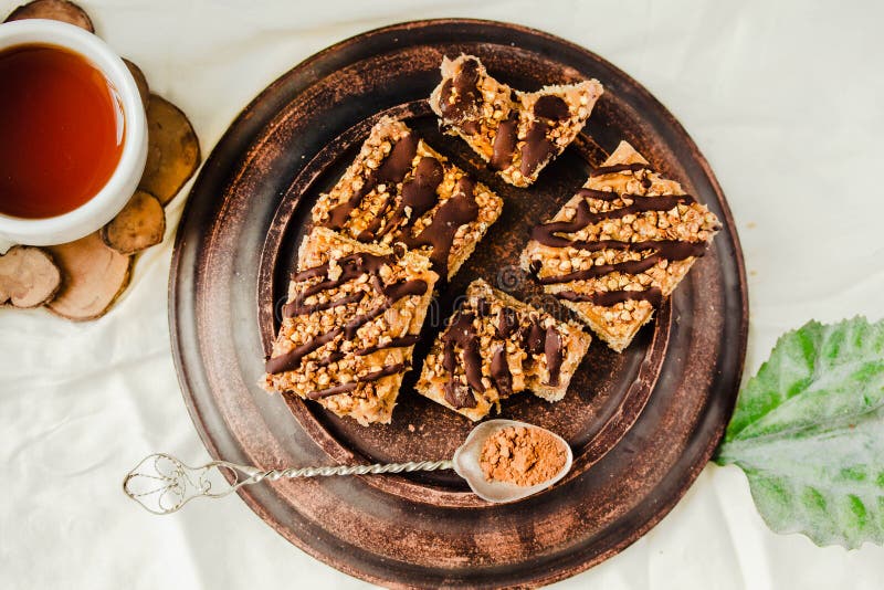 Granola bar cake with date caramel and chocolate. Healthy sweet dessert snack. Cereal granola bar with nuts, fruit and berries on royalty free stock images Granola bar cake with date caramel and chocolate. Healthy sweet dessert snack. Cereal granola bar with nuts, fruit and berries on royalty free stock images