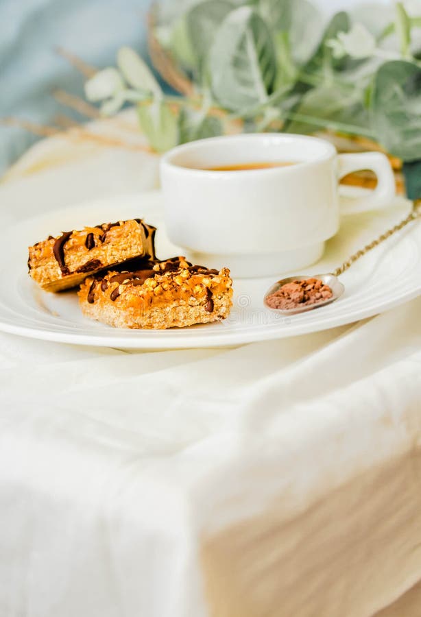 Granola bar with date caramel and chocolate. Healthy sweet dessert snack. Selective focus. A cup of coffee. Healthy breakfast. royalty free stock images Granola bar with date caramel and chocolate. Healthy sweet dessert snack. Selective focus. A cup of coffee. Healthy breakfast. royalty free stock images