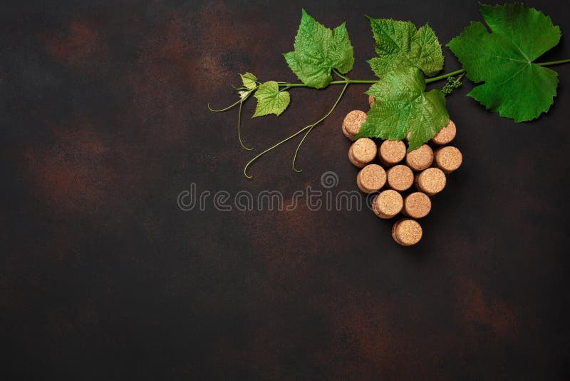 Grape bunch of cork with leaves on rusty background