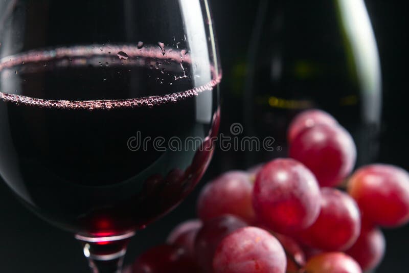 Grape and glass with red wine