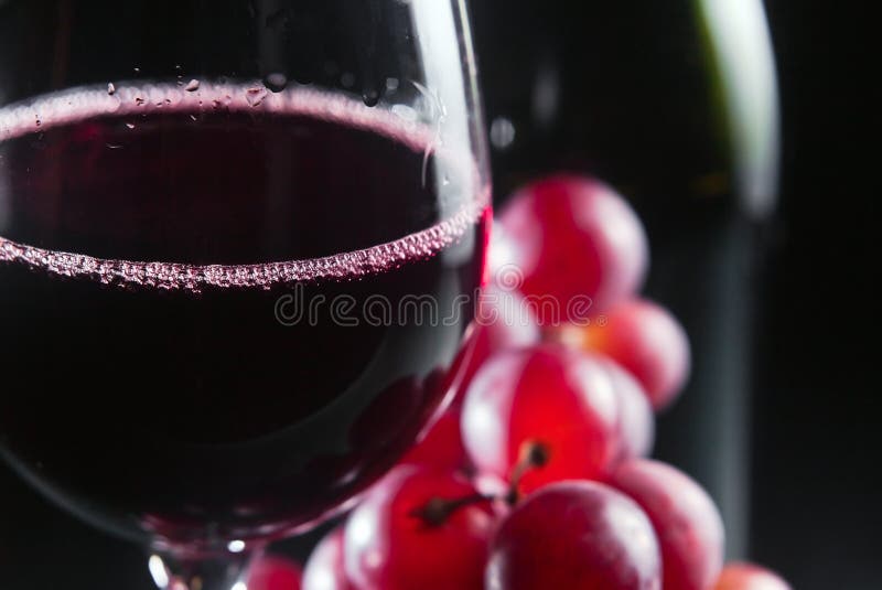 Grape and glass with red wine