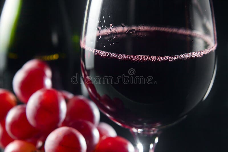 Grape and glass with red wine