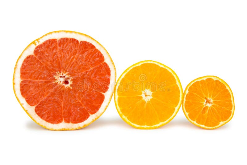 Grapefruit, orange and tangerine cut in half and lined up with a cross-section towards the camera