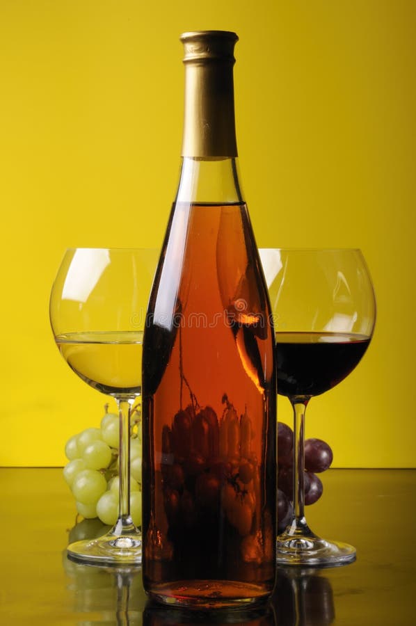 Grapes, bottle and two glasses of wine stock photos