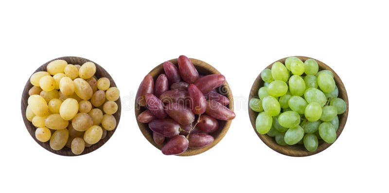 Grapes in a wooden bowl isolated on white background. Yellow, pink and green grapes on white background. royalty free stock image Grapes in a wooden bowl isolated on white background. Yellow, pink and green grapes on white background. royalty free stock image