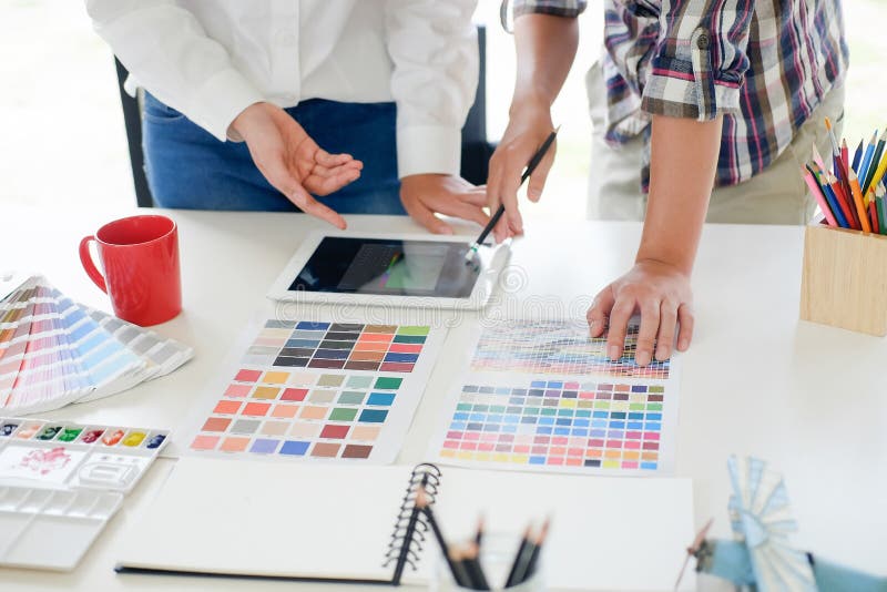 Graphic design meeting with tablet computer on workplace. royalty free stock images Graphic design meeting with tablet computer on workplace. royalty free stock images