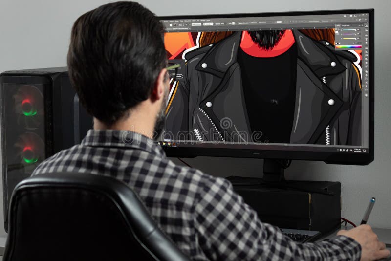 A graphic designer man backward drawing a vectorial illustration into adobe illustrator sofware in a gamer computer stock photos