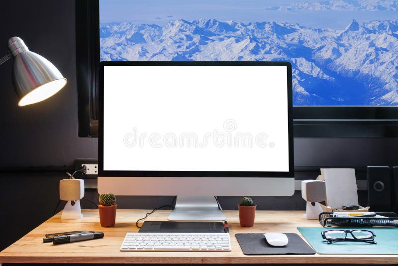 Graphic designer`s workspace with a pen tablet, a computer and white backgroud for text with beautiful view of Snow moutain,Franc