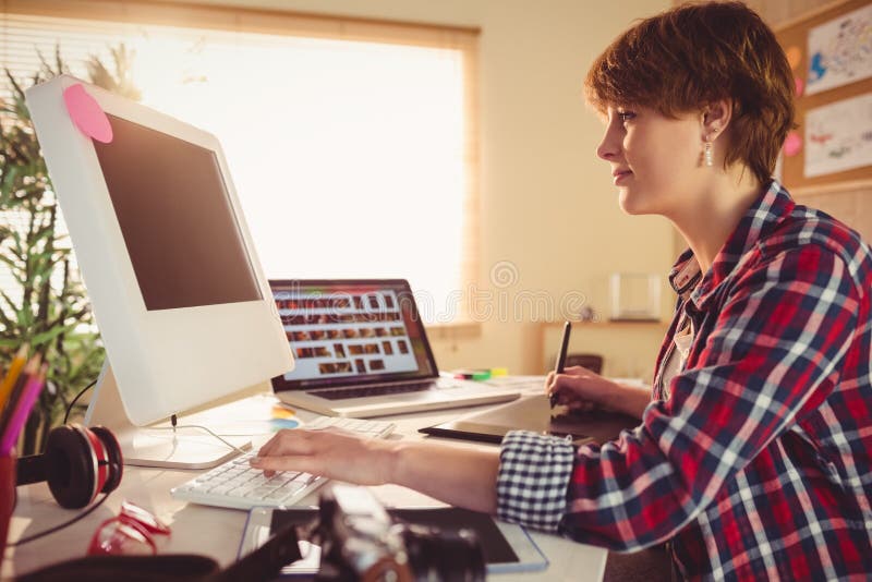 Female Graphic Designer Having Discussion with Coworkers Stock Image