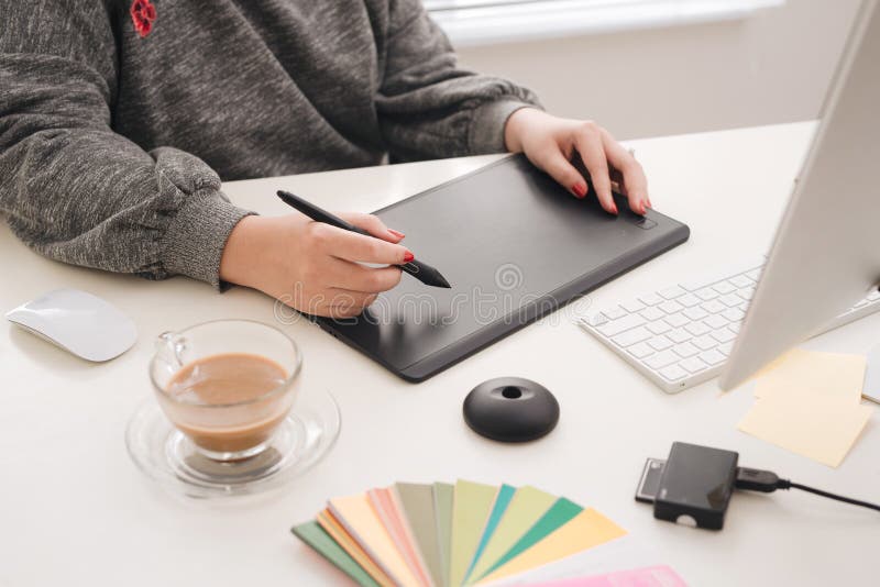 Graphic designer working with digital drawing tablet at office. stock photo