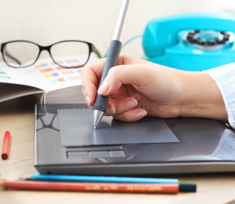 Graphic designer working in office with tablet pen stock photography
