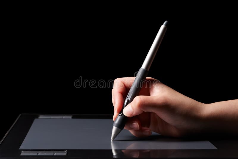 Hand of the designer with a pen on a tablet. Hand of the designer with a pen on a tablet