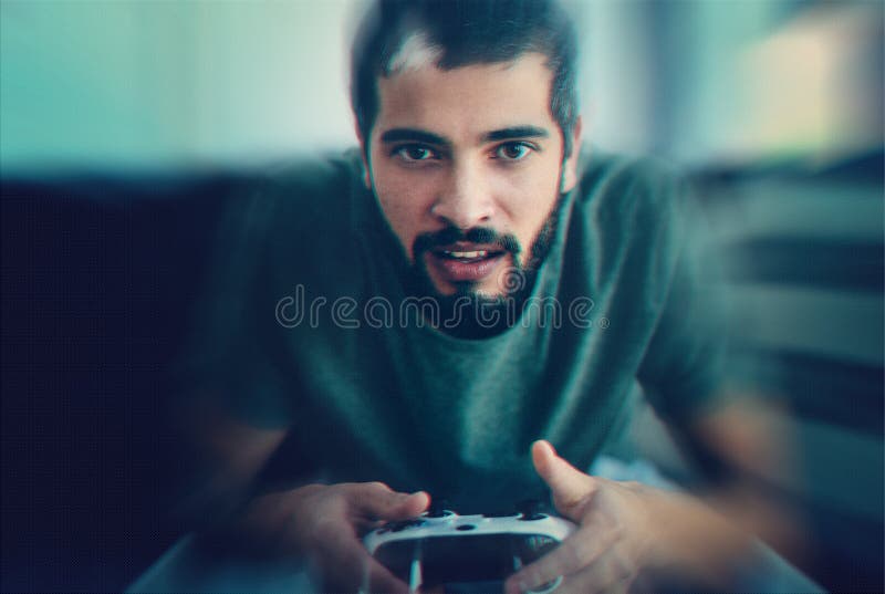 The Graphics on this Game is Amazing. a Young Man Sitting on the Couch while Playing Video Games