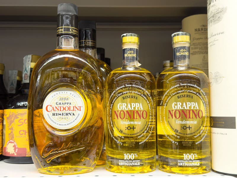 Grappa Bottles on Shelf: Candolini and Nonino Varieties in Liquor Store ... Grappa Bottles on Shelf: Candolini and Nonino Varieties in Liquor Store ...