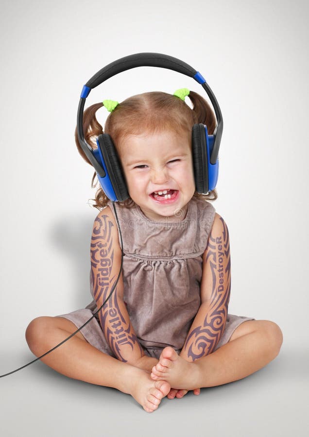 Grappig kindmeisje met tatoo het luisteren muziek met hoofdtelefoons royalty-vrije stock afbeelding Grappig kindmeisje met tatoo het luisteren muziek met hoofdtelefoons royalty-vrije stock afbeelding