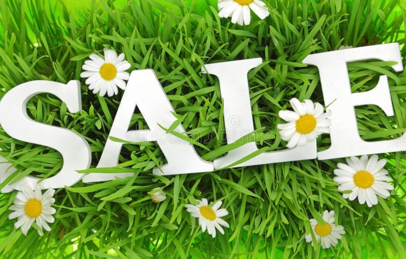 Grass with flowers and white text Sale
