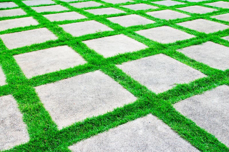 Grass growth between cement walkway royalty free stock photography