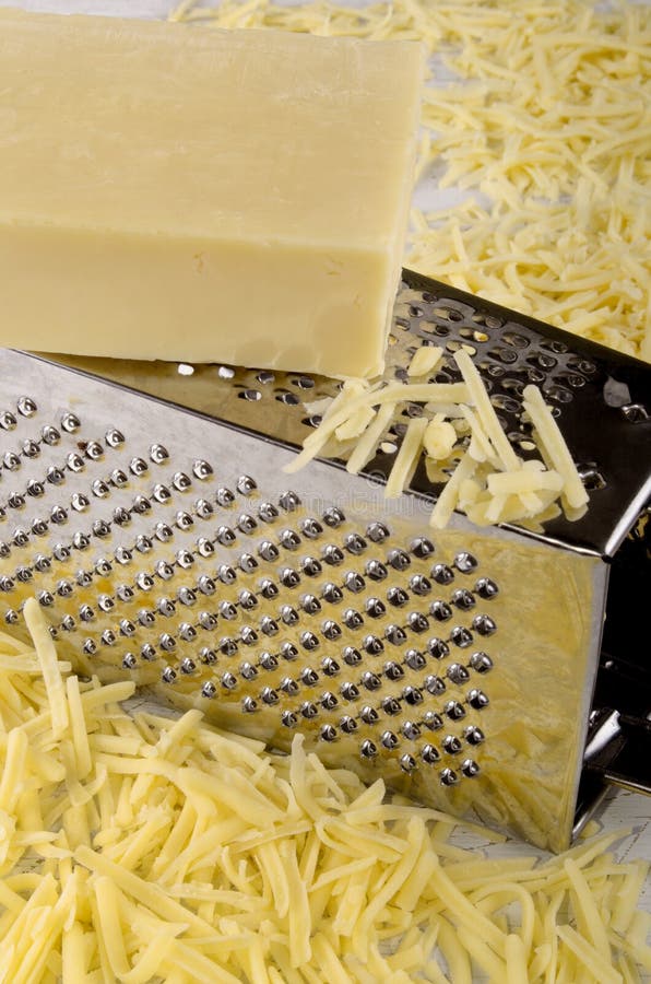 Grated cheddar cheese stock photo. Image of equipment 33242714