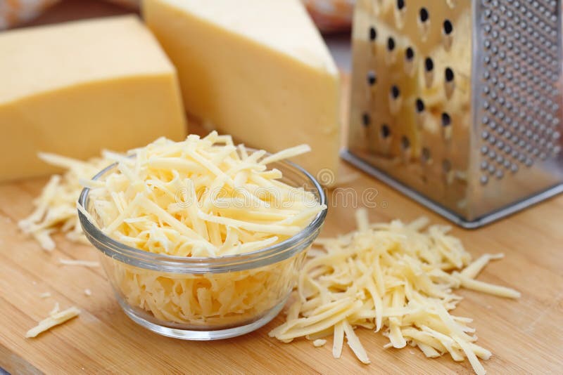 Grated cheese in a bowl stock image. Image of slice, orange 65448931
