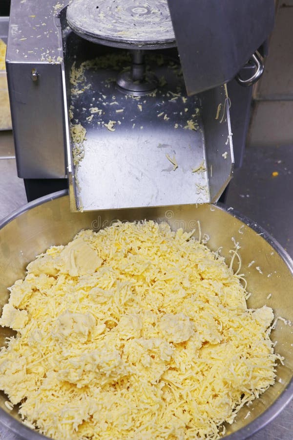 https://thumbs.dreamstime.com/b/grated-cheese-making-electric-grater-machine-240150629.jpg