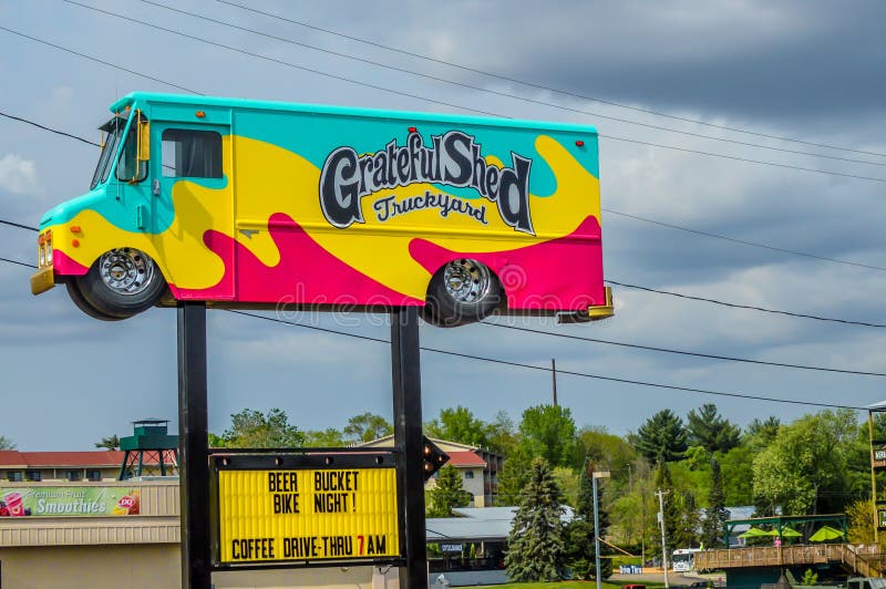 pink and teal ice cream shake sundae truck van on a street