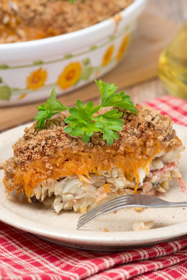 Gratin with fish and pumpkin on a plate, vertical