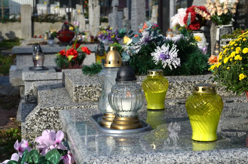 Candles On The Grave In The Cemetery / Graveyard. All Saints Day / All