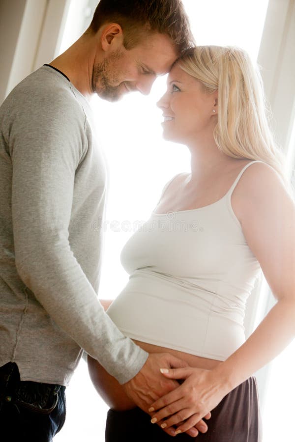 Pregnant women holding hands around her belly. Pregnant women holding hands around her belly