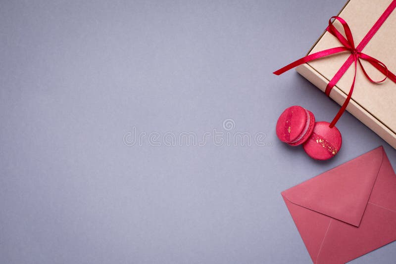 Gray background with gift envelopes , gift box and macaroons top view. Concept clean layout stock images, royalty-free photos and pictures