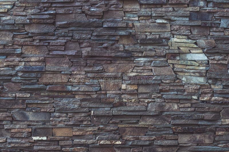 Gray and brown dilapidated stone texture of facade building. Rough brickwork, dirty weathered, grey dilapidated wall background. G royalty free stock photo