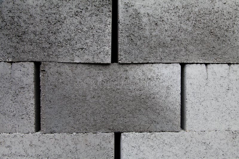 Gray building cinder blocks made of cement stacked close-up background. stock images
