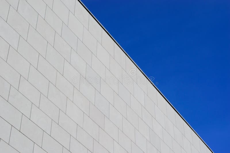 Gray Cement Brick Wall of Corporate Building Facade on Blue Sky