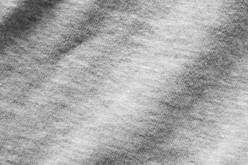 Gray fabric texture background of dark grey colored shirt. Cloth