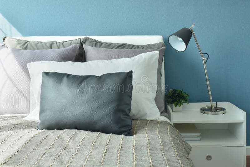 Gray, Dark Gray and White Color Pillows on Bed with Modern Style Stock