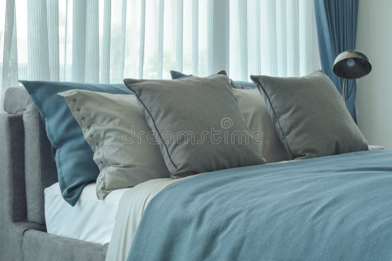 Gray and Deep Blue Pillows Setting on Bed in Deep Blue Color Scheme