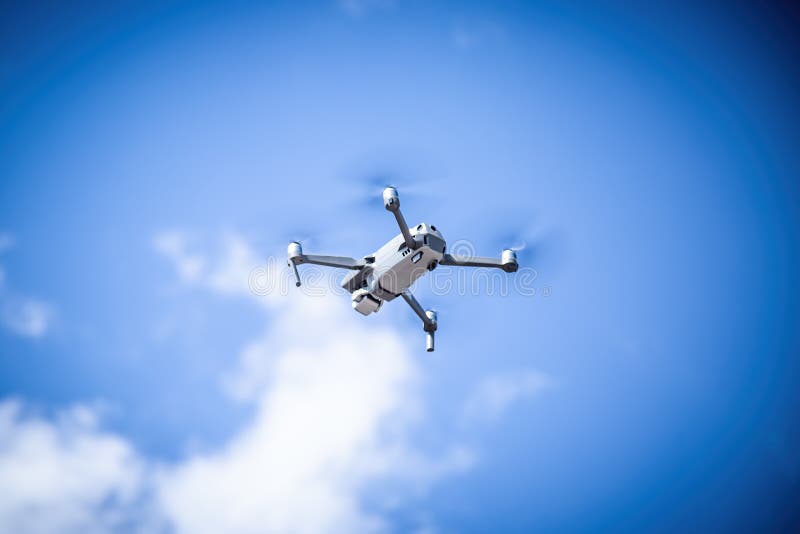 A Gray Drone Flies Low in a Car Park. Against the Background of a Car in  Blur Stock Image - Image of aviation, gray: 162942223