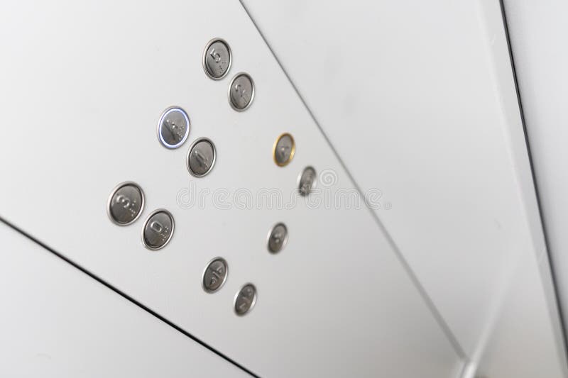 Gray elevator panel with silver buttons in a building