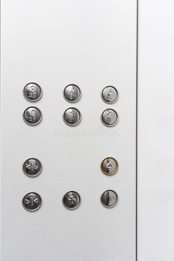 Gray elevator panel with silver buttons in a building