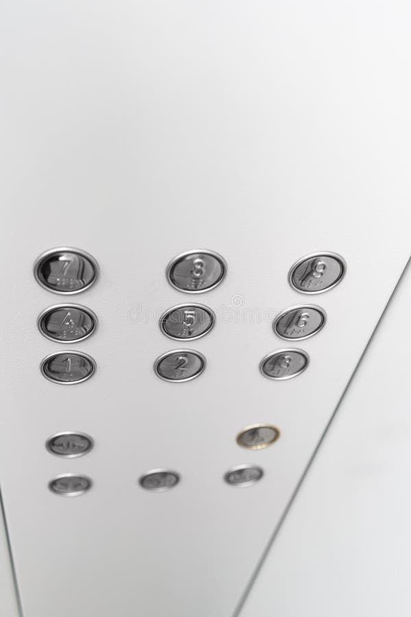 Gray elevator panel with silver buttons in a building
