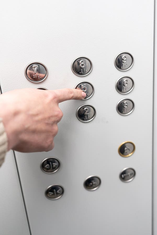 Gray elevator panel with silver buttons in a building