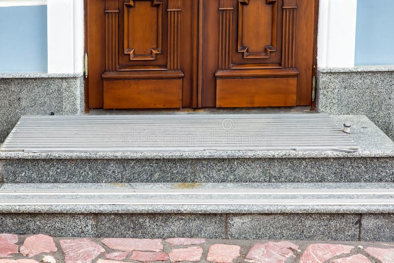 Gray granite threshold with steps covered with non-slip rubber strips. stock images