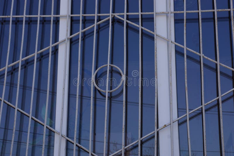 Gray Metal Texture of Iron Rods in a Pattern on the Window Glass Stock