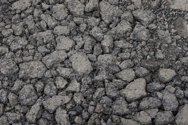 Gray stone texture of asphalt pieces with cracks on the road. Gray stone background of pieces of asphalt with cracks on the road stock photo Gray stone texture of asphalt pieces with cracks on the road. Gray stone background of pieces of asphalt with cracks on the road stock photo