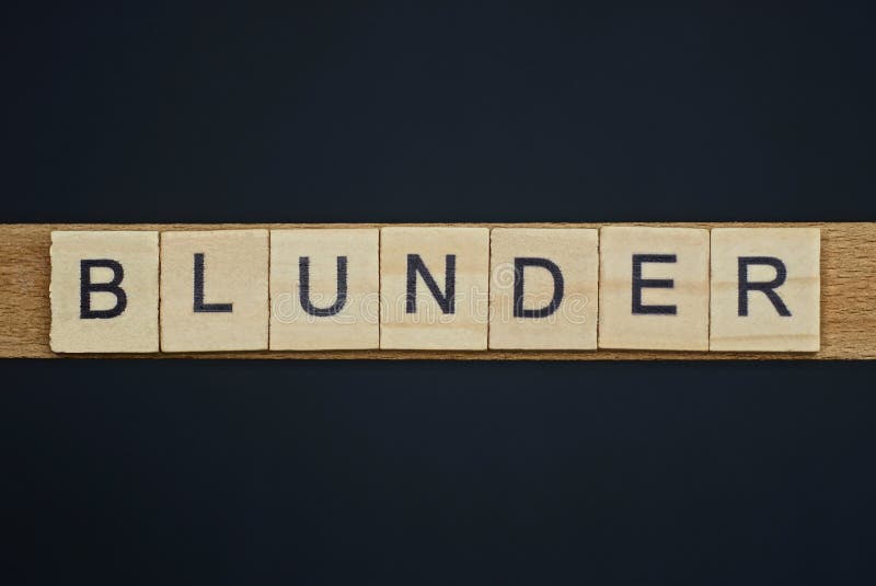 Gray word blunder from small wooden letters on a black table