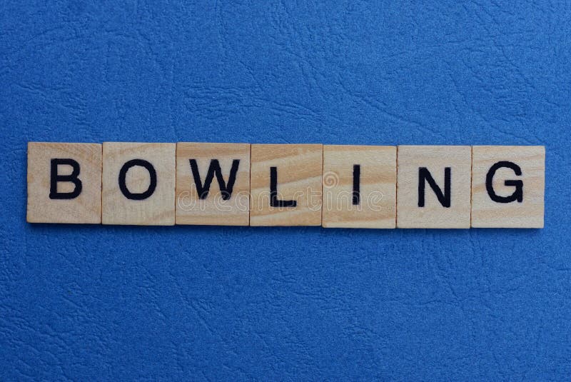 Gray word bowling from small wooden letters on a blue table