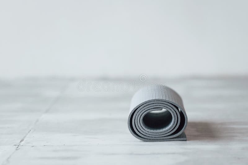 Gray Yoga Mat Lying Down on the Wooden Floor in the Studio Stock Image