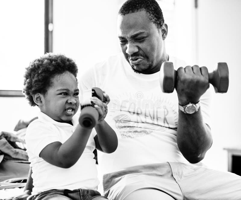 Grayscale of black family exercising